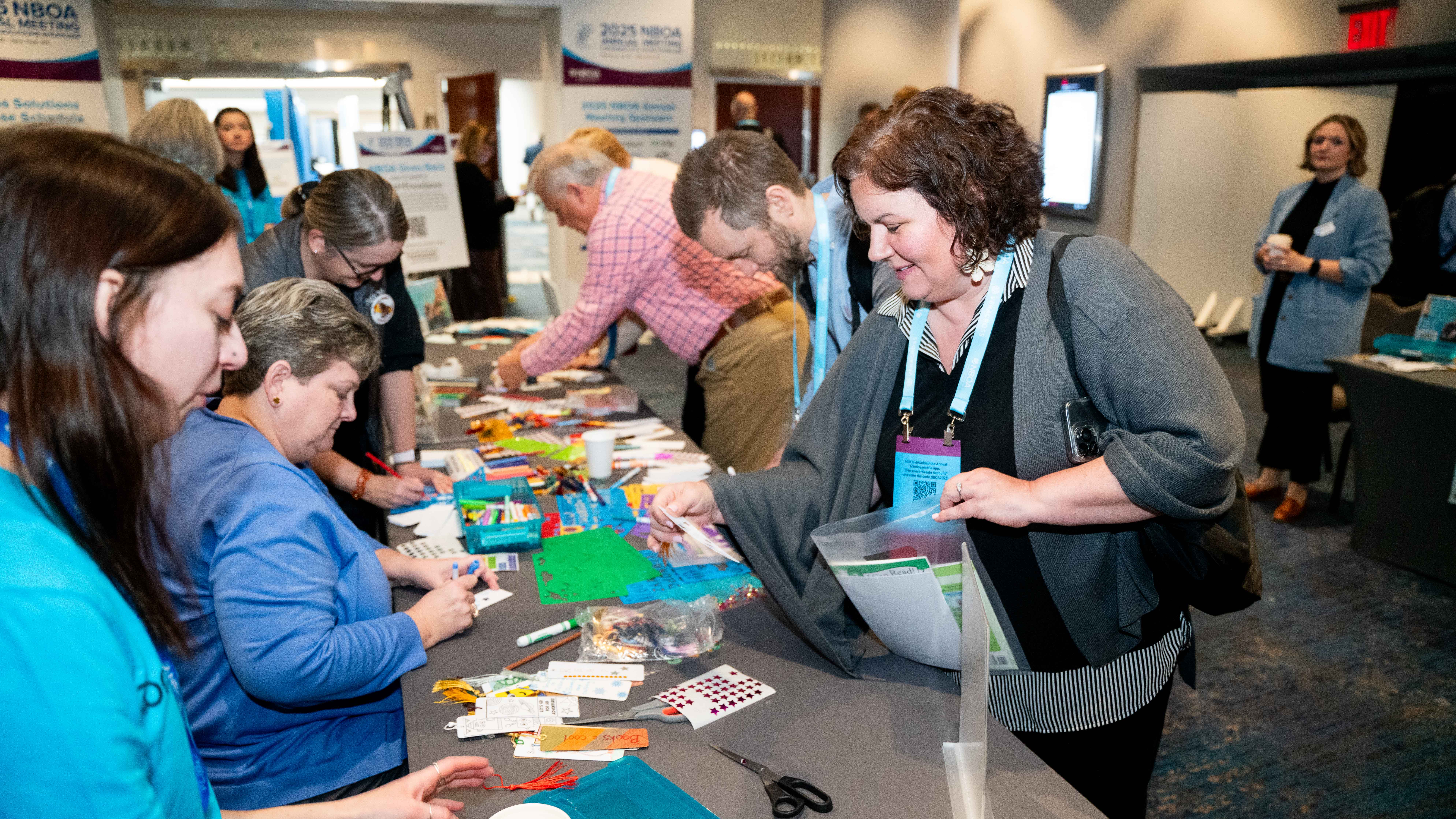 Attendees at the 2025 NBOA Annual Meeting assemble literacy kits 
