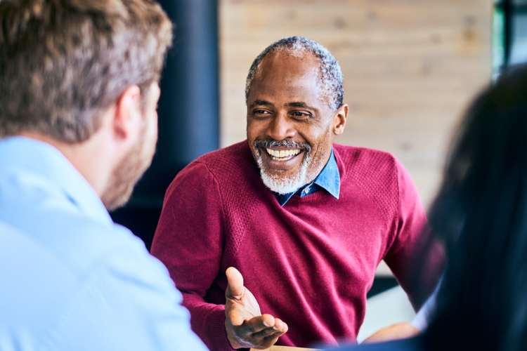 Stock image of black business man at table