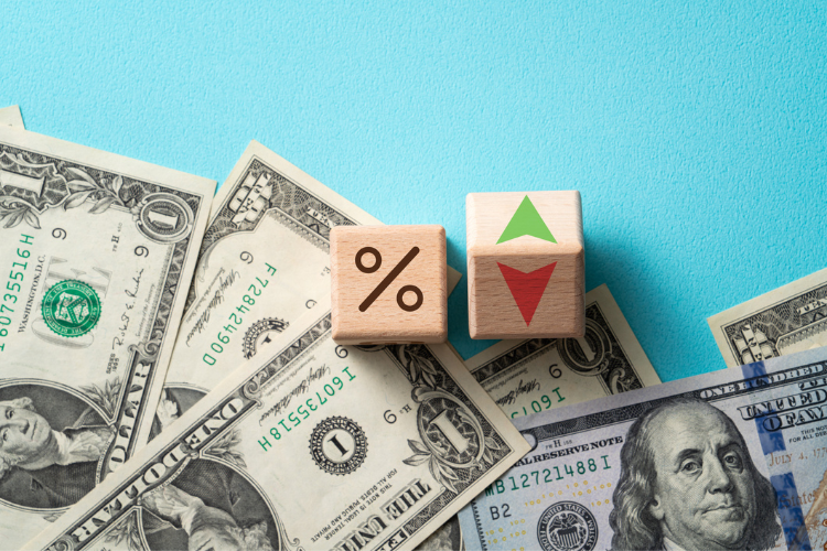 stock image of wooden blocks on dollar bills
