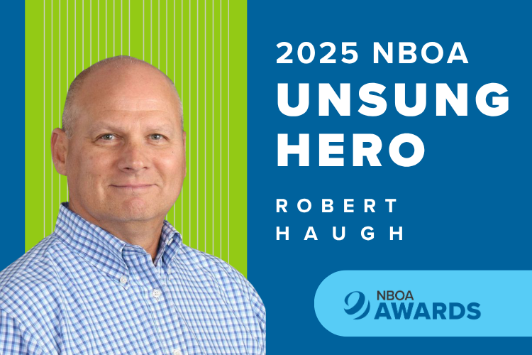 Photo of Robert Haugh, a white man in a blue and white shirt, against a blue and green NBOA background