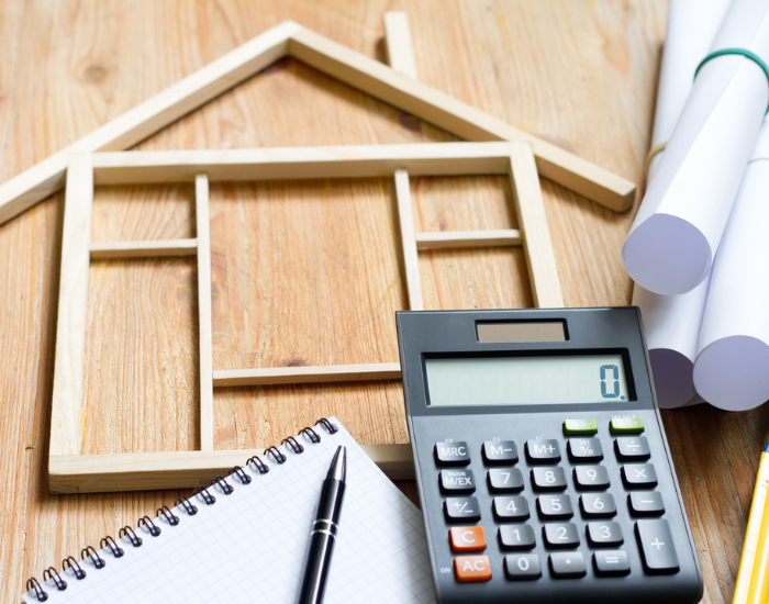 stock image of building plans and calculator