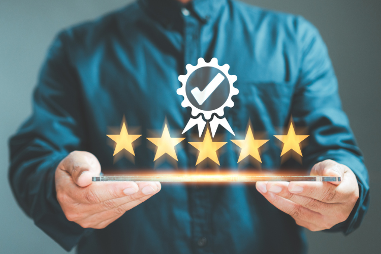 Stock image of  a man hand holding a tablet with a quality check image above the tablet