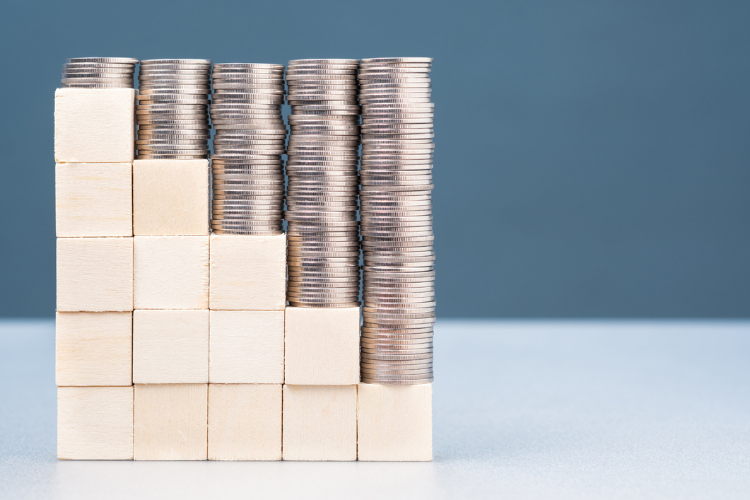 stock image of coins and wooden blocks